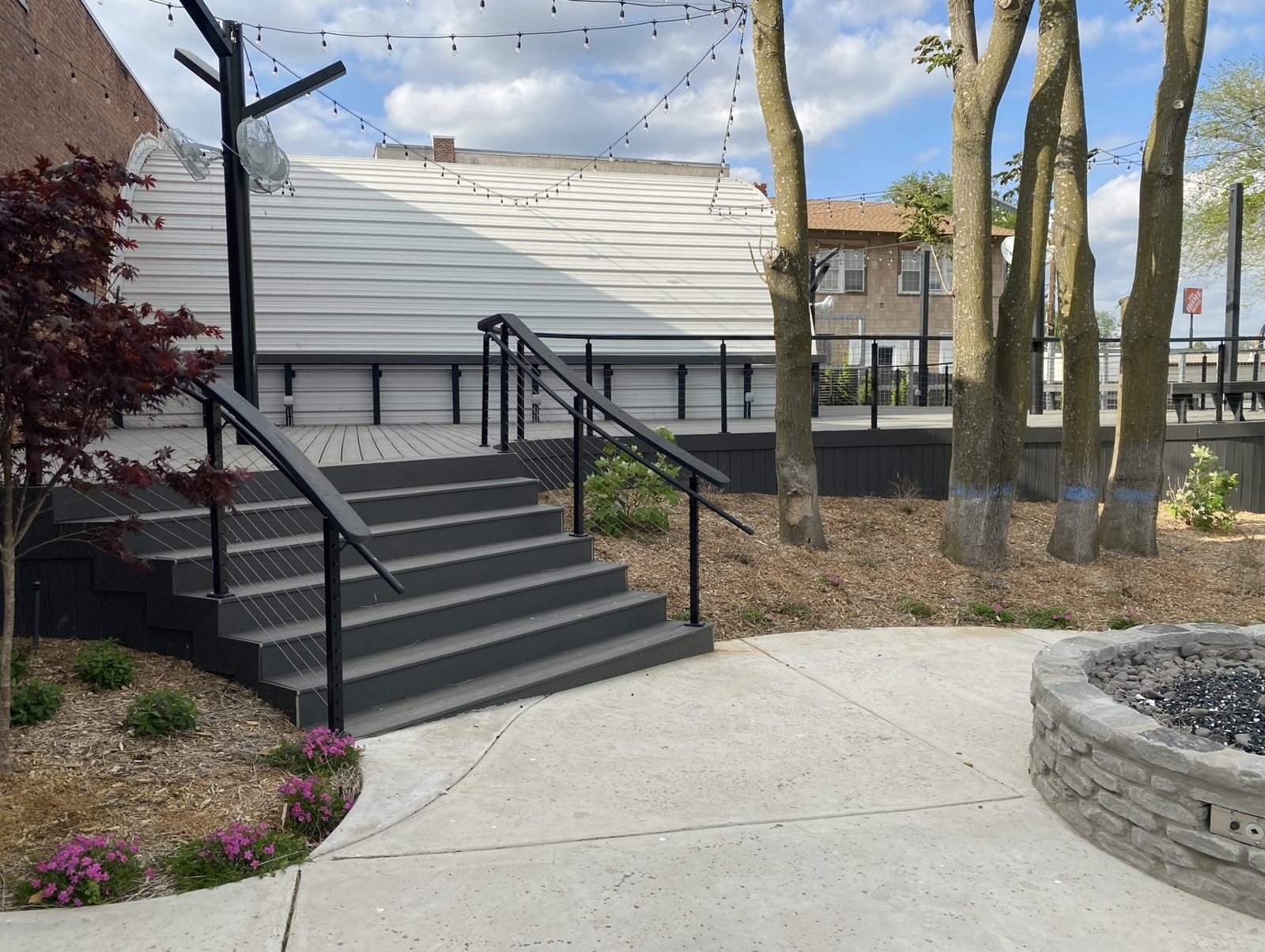 The Hut deck with stairs and fire pit